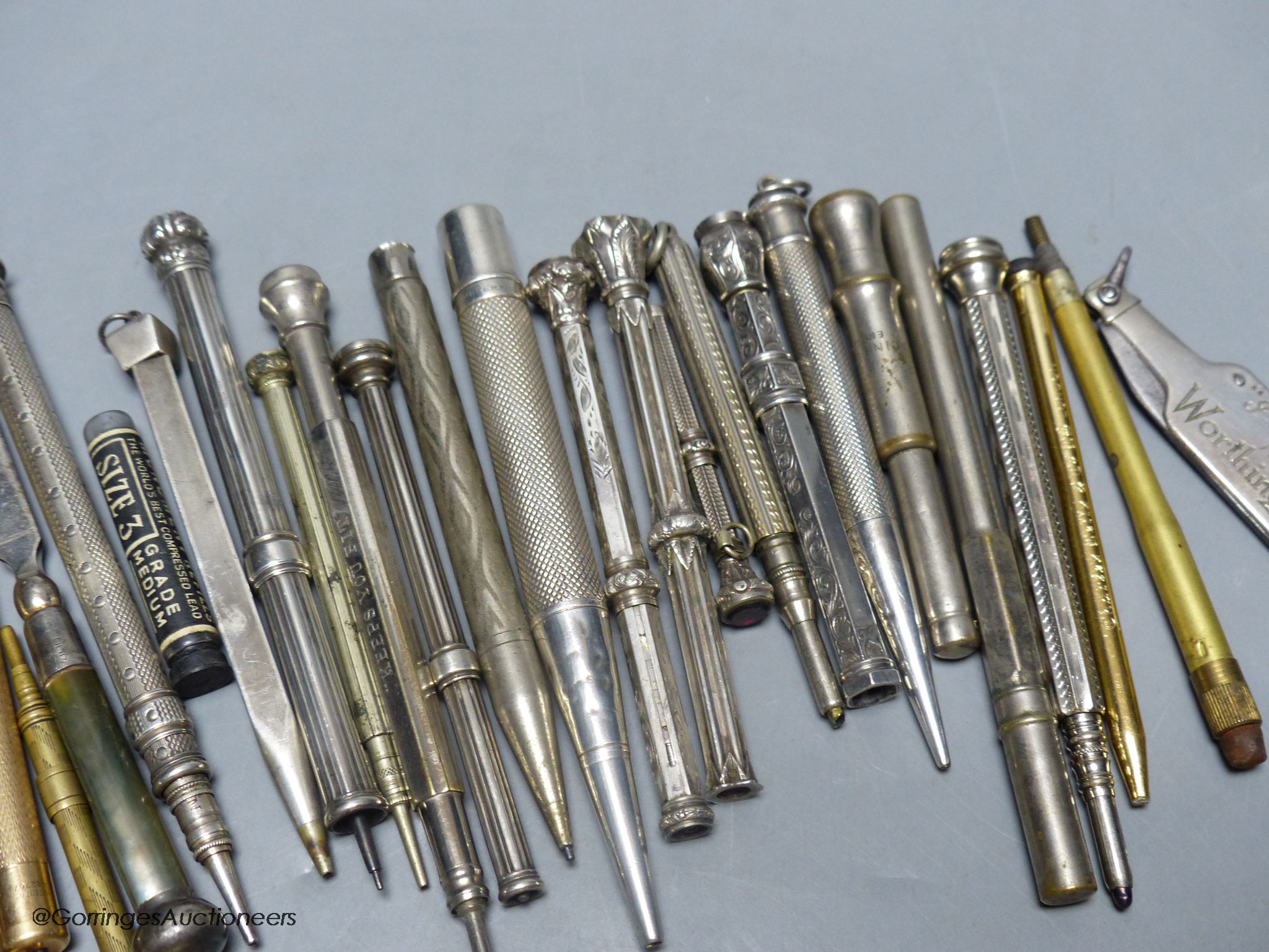 A group of silver and metal propelling pencils